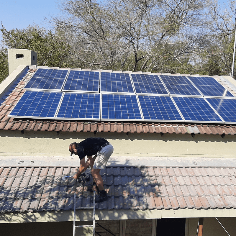Battery warehouse employee installing solar panels